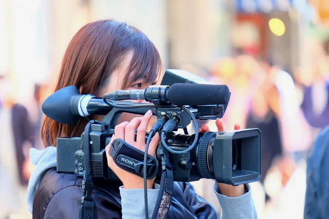 female, cameraman, shooting, video recording, street, cameraman, cameraman, cameraman, cameraman, cameraman. Choosing creators for a single-city promotion